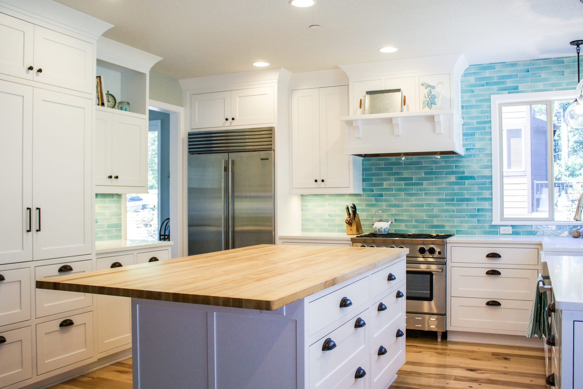 Custom designed kitchen with white and bold blue backsplash